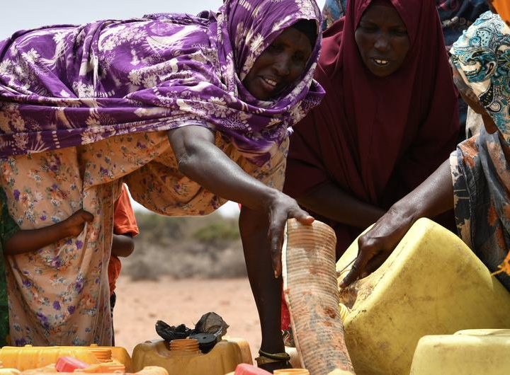 A group of women fetch water at a water trucking point in Kureyson village, Galkayo, Somalia.