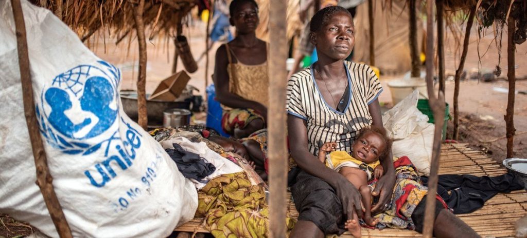 A woman in Tanganyika Province, Democratic Republic of the Congo, poses with her severely malnourished child.