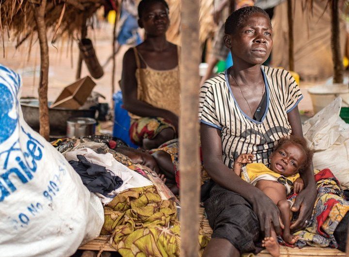 A woman in Tanganyika Province, Democratic Republic of the Congo, poses with her severely malnourished child.