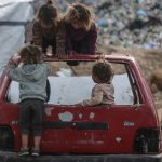 Children play on the wreck of a car in Gaza.