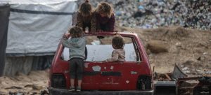 Children play on the wreck of a car in Gaza.