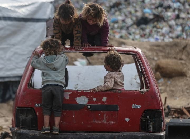 Children play on the wreck of a car in Gaza.