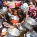 People clamour for food in Gaza.