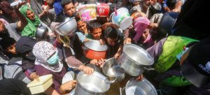 People clamour for food in Gaza.