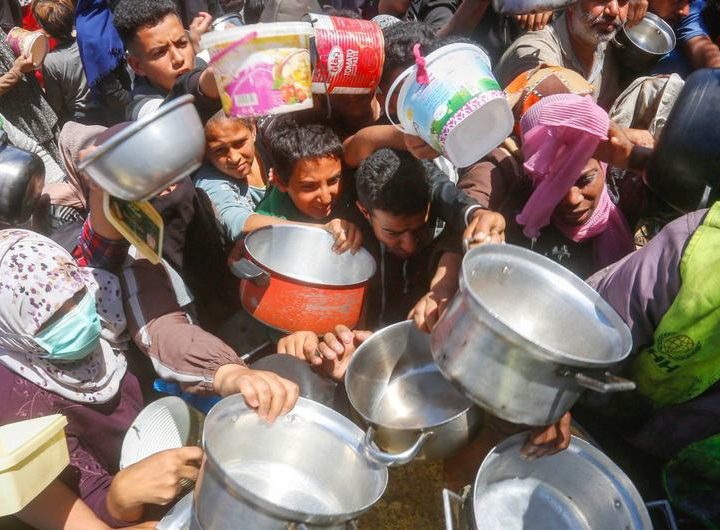 People clamour for food in Gaza.